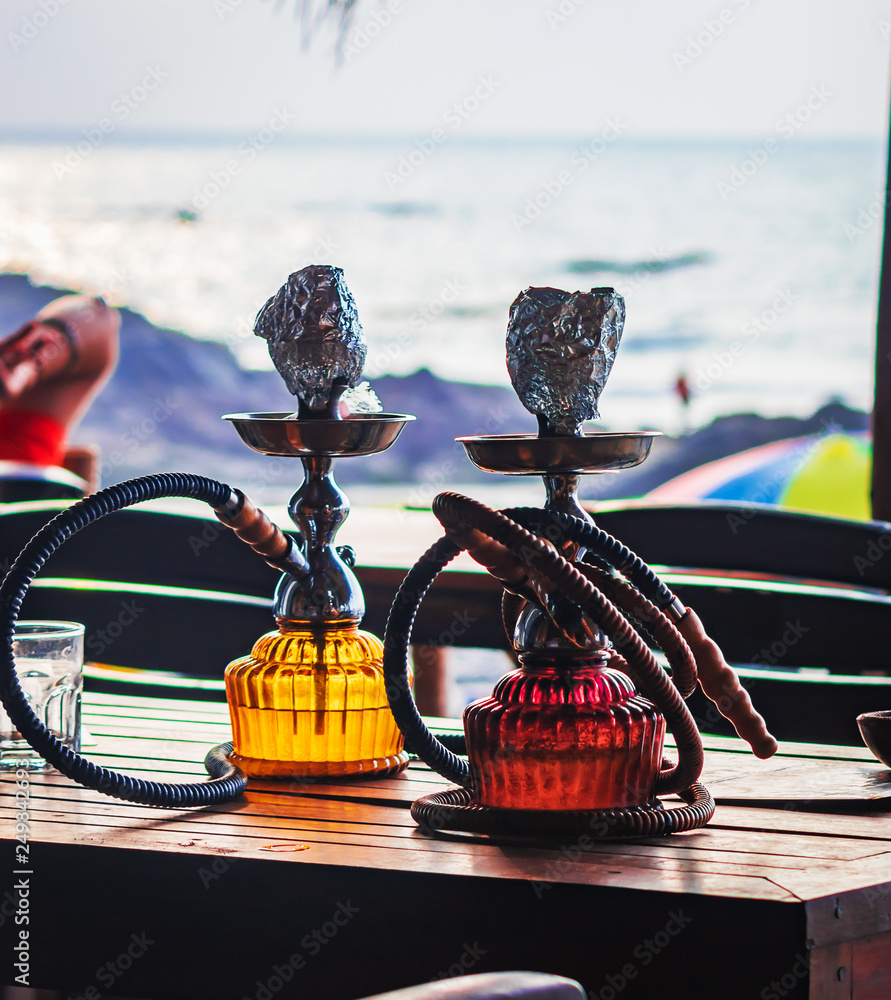 set of hookah shisha smoke on beach background in Goa for travellers