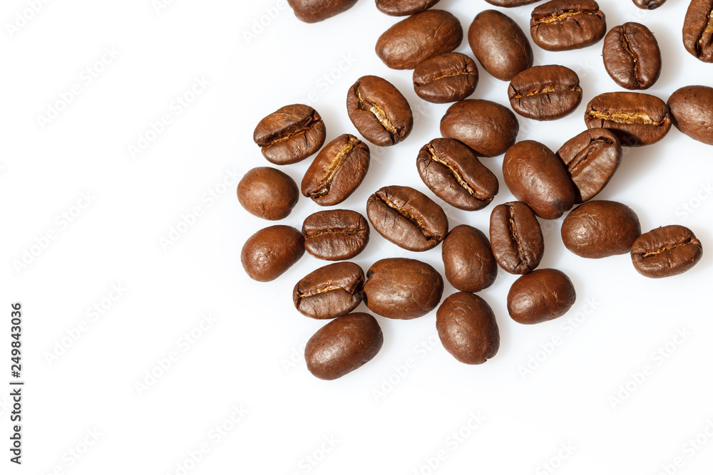 Roasted coffee beans isolated on white can be used as background or texture. Close up. Roasted coffee beans isolated on white can be used as background or texture. Close up.
