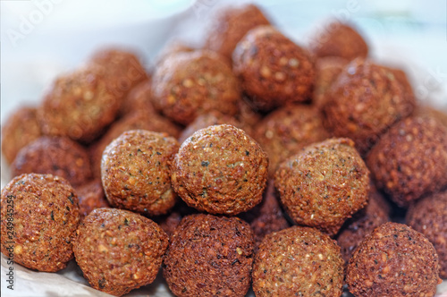 Deep frying falafel. Traditional Mediterranean healthy and vegan food with chickpeas and tahini. Selective focus, shallow depth of field
