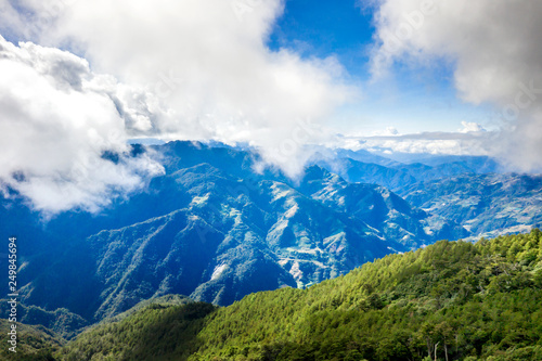 Flying drone towards beautiful amazing famous Mt. Hehuan in Taiwan over above the hilltop, aerial view shot.