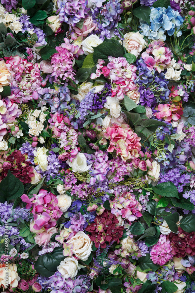 Multi-colored wallpaper of hydrangea flowers and roses.