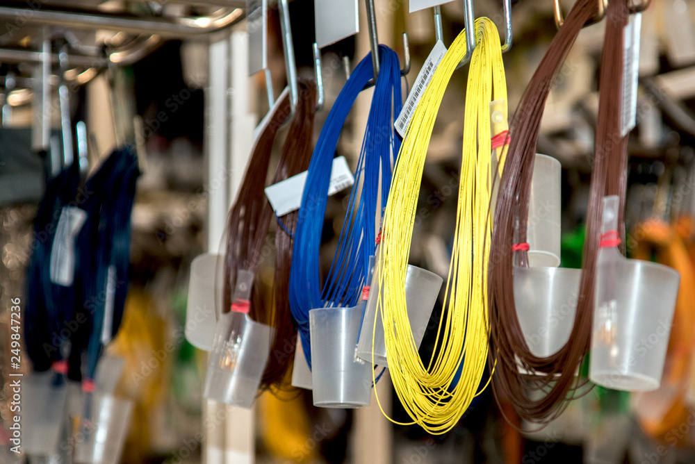 Industrial landscape with shelves of colored wire ropes at a modern plant for the production of wiring for automobiles. Logistics