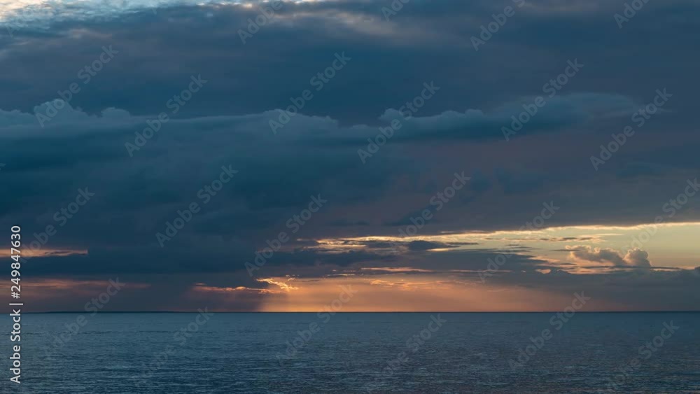 Time lapse of clouds slowly drifting above sea during sunset Time lapse of clouds slowly drifting above sea during sunset