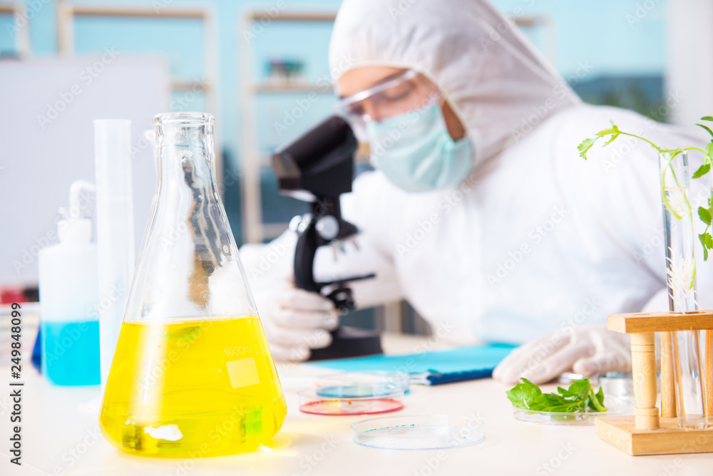 Male biotechnology scientist chemist working in the lab Male biotechnology scientist chemist working in the lab