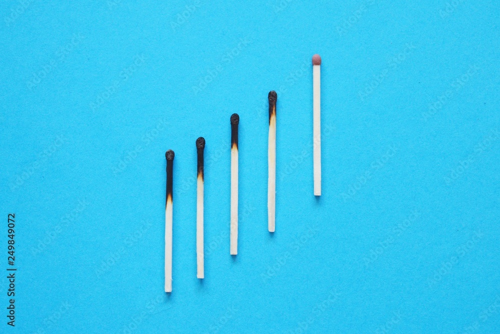 Business concept. Matches on blue background.
