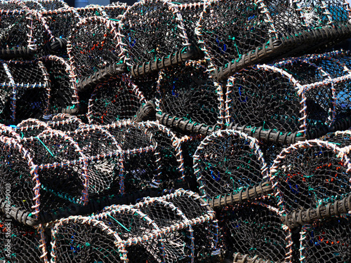 Fishing Industry lobster pots stacked on quayside.