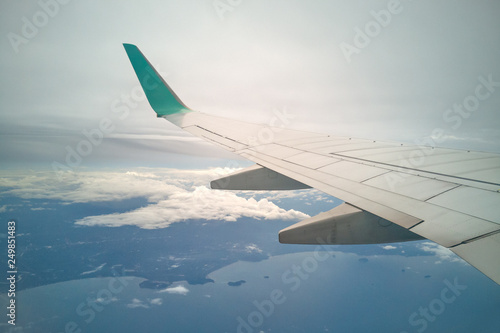 wing of airplane and sky landscape. the earth and the blue sea background