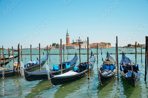 Gondolas moored by Saint Mark square with San Giorgio di Maggiore church in Venice, Italy © Marharyta