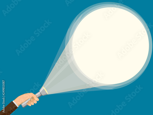Flashlight in hand of man. Background illuminated by a spotlight.