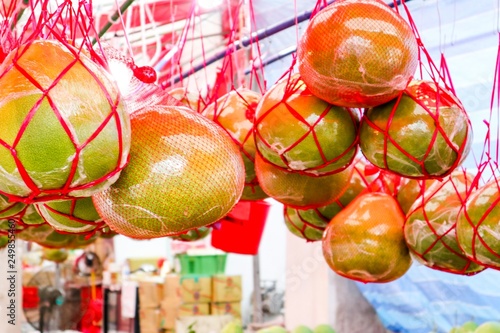pomelos hanging in market