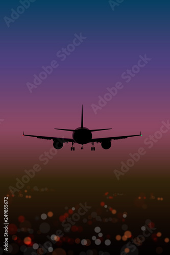  airplane on the background lights of the night city bokeh effect top view at sunset
