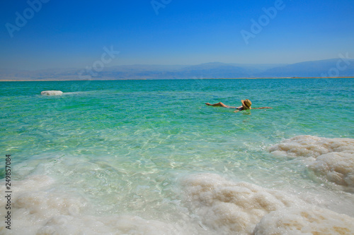 Girl relaxing in the water of Dead Sea