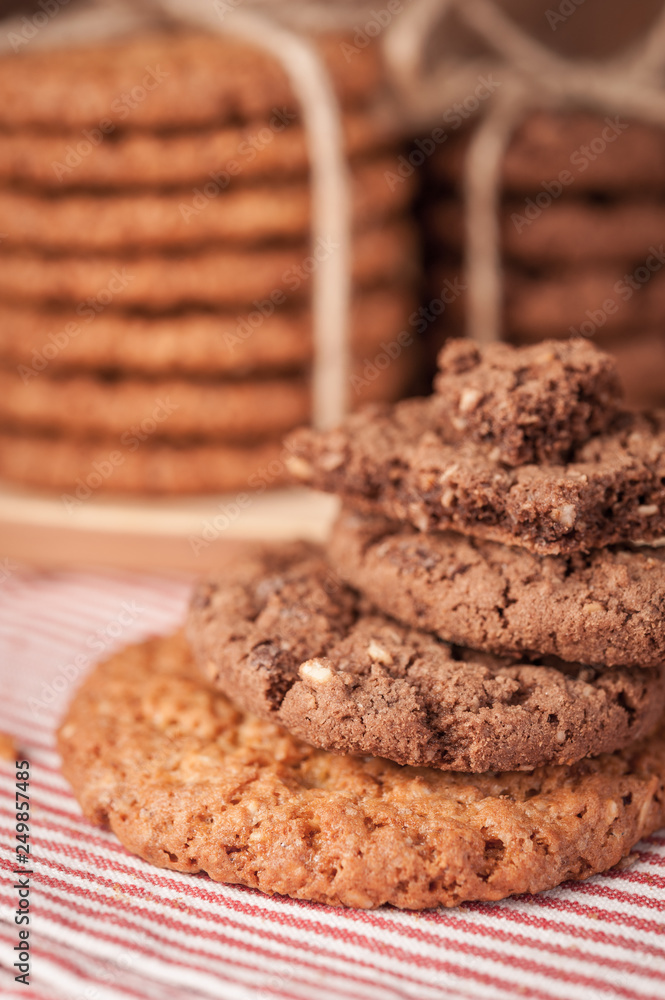 Fototapeta premium Various shortbread, oat cookies, chocolate chip biscuit on dark rustic wooden table.