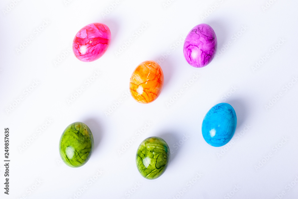 Colorful painted easter eggs laying on white background