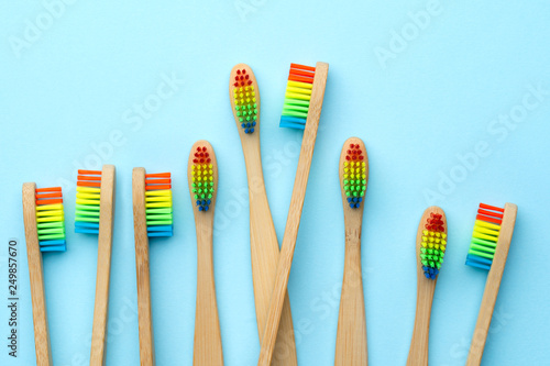 Photo of many toothbrushes with rainbow-colored bristles.