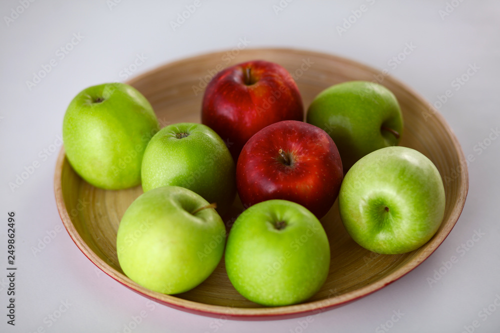 wooden plate with ripe fresh red and green apples wooden plate with ripe fresh red and green apples