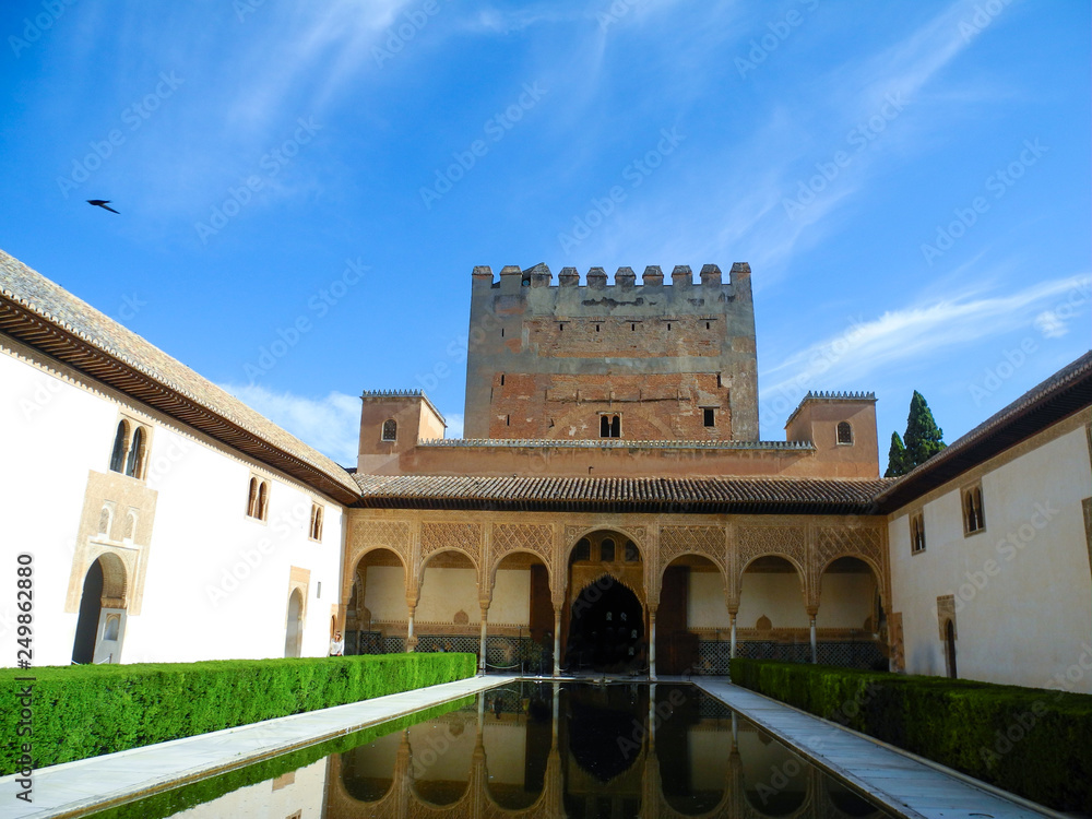 Fototapeta premium Alhambra palace view, Granada, Andalusia region, Spain. Beautiful summer day with blue clear sky. 