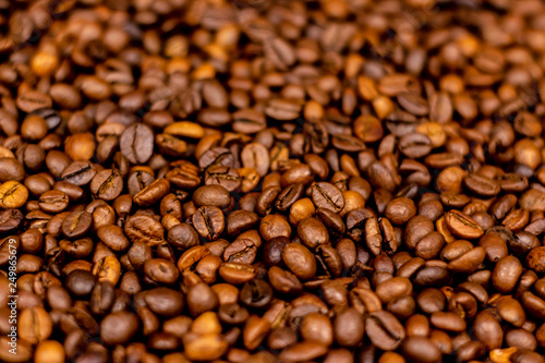 Coffee beans bright saturated texture. Roasted coffee beans background.