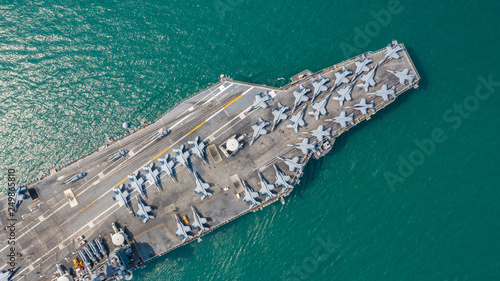 Navy Nuclear Aircraft carrier, Military navy ship carrier full loading fighter jet aircraft, Aerial view.