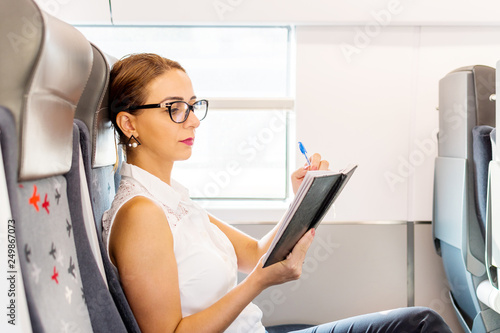 business woman reading diary on the train