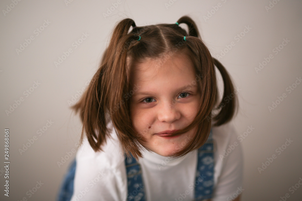 kid girl with funny tails and grimace, Fool's day kid girl with funny tails and grimace, Fool's day
