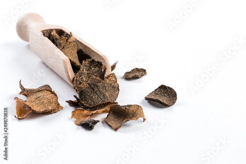 Truffles in wooden scoop isolated on white background. Closeup.