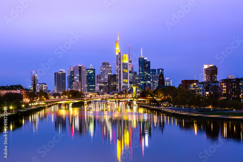 Panoramic view cityscape skyline of business district with skyscrapers and mirror reflections in the river Main during sunset blue hour  Frankfurt am Main. Hessen  Germany