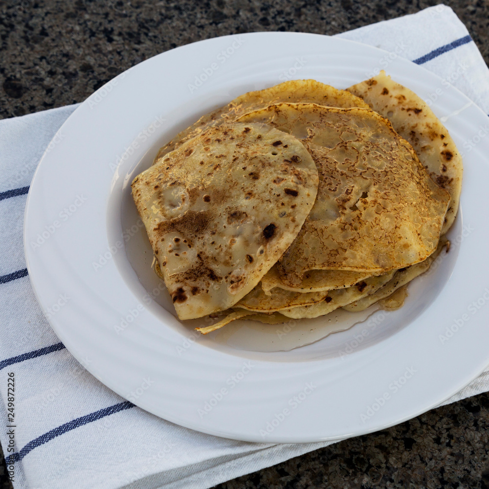 Homemade pancakes with honey for breakfast, low angle view. Homemade pancakes with honey for breakfast, low angle view.