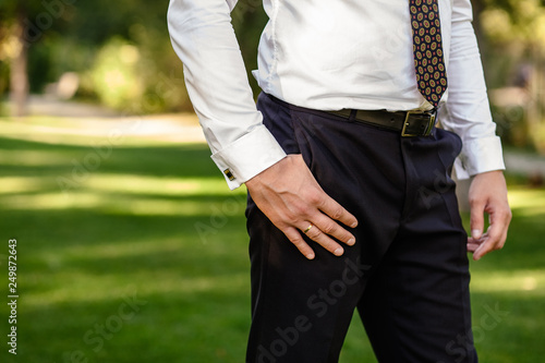 Businessman in the park with hand in pocket