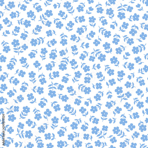 Seamless ditsy floral pattern in vector. Small blue flowers on a white background.