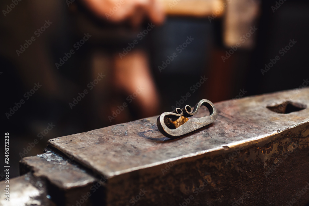 closeup of a blacksmith anvil with a firesteel and flint. closeup of a blacksmith anvil with a firesteel and flint.