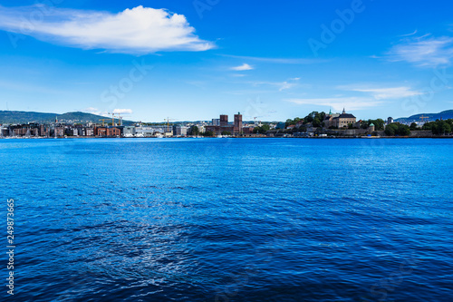 Oslo skyline in a sunny day viewed from Hovedoya island. In the middle Oslo City Hall, on the right the Akershus fortress