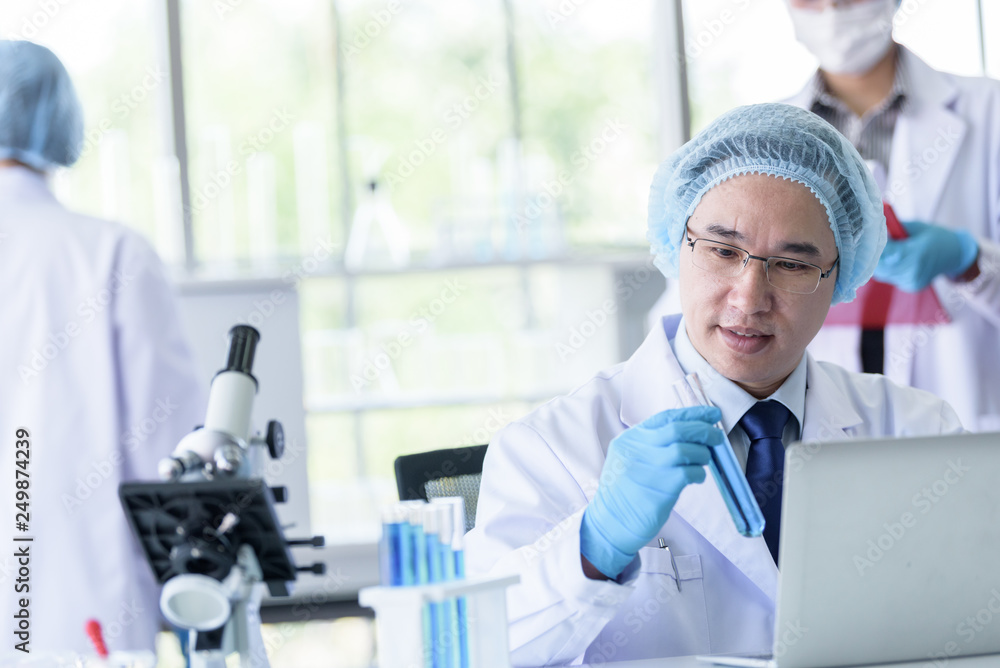 Fototapeta premium Asian senior scientist male researching and learning in a laboratory.