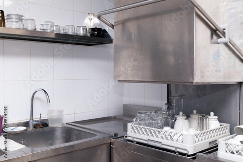Clean utensils in the dishwasher. Wine glasses, beer mugs, ceramic teapots. Concept of preparation for opening, banquet, catering, buffet table