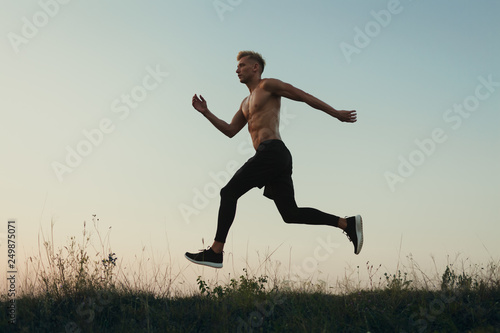 Sportsman in motion of running in nature