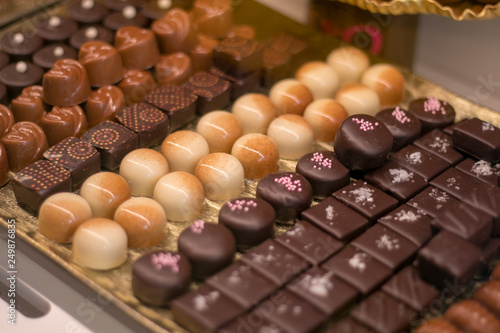 Assortment of handmade chocolate candies from black  milk and white chocolate with nuts and marzipan in San Miguel Market Madrid