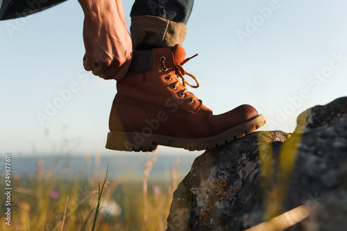 Crop tourist putting on boot photo