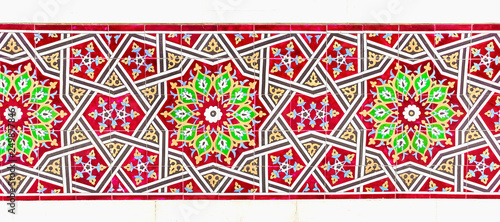 traditional Uzbek pattern on the ceramic tile on the wall of the mosque, background