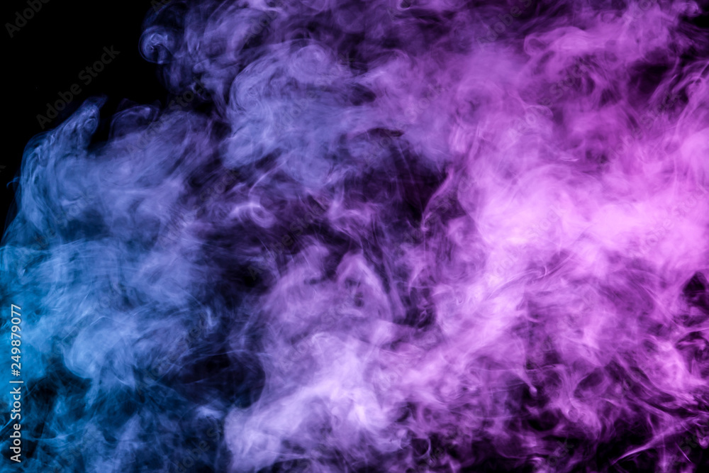 Translucent, thick smoke, illuminated by light against a dark background, divided into three colors: blue, green, pink and purple, burns out, evaporating from a steam of vape for print on t-shirt