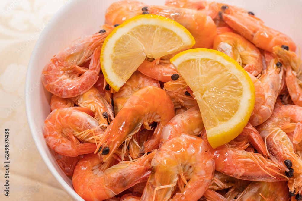 tasty boiled tiger prawns with lemon slices on a white plate. close up tasty boiled tiger prawns with lemon slices on a white plate. close up