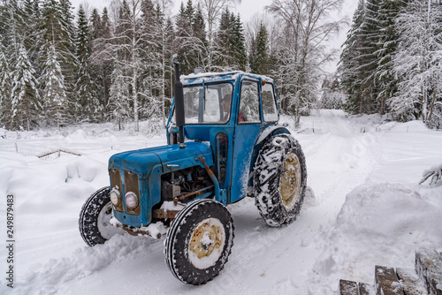 old blue fordson dexta tractor plowing snow photo