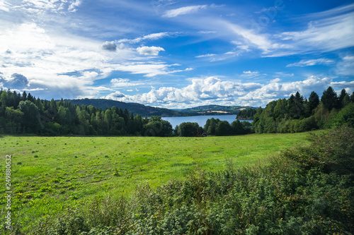 Norwegian landscape in Hedmark county during summer near Mjosa lake, viewed from the scenic railway connecting Oslo to Trondheim