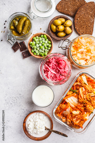 Probiotics food concept. Kimchi, beet sauerkraut, sauerkraut, cottage cheese, peas, olives, bread, chocolate, kefir and pickled cucumbers.