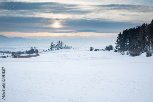 Europe, country Slovakia, region Turiec. Sunrise on winter landscape, beautiful church in the village of Abramova.