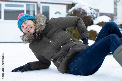 Woman In Pain Falling Over In Snowy On Slippery Street And Injuring Herself