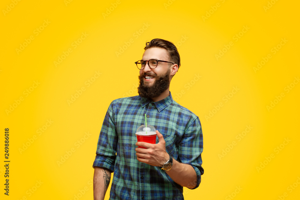 Cheerful hipster with fresh beverage Cheerful hipster with fresh beverage