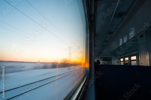 forests and fields in the rays of dawn through the window of a speeding train © Павел Чигирь