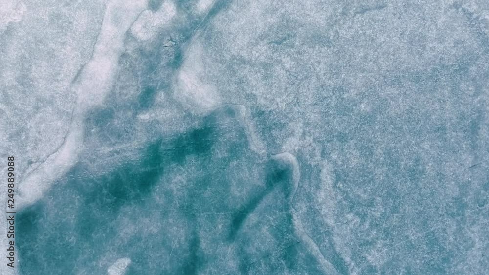 Aerial HD video top of view of frozen lake in winter time. It is beautiful snowy background. Aerial HD video top of view of frozen lake in winter time. It is beautiful snowy background.