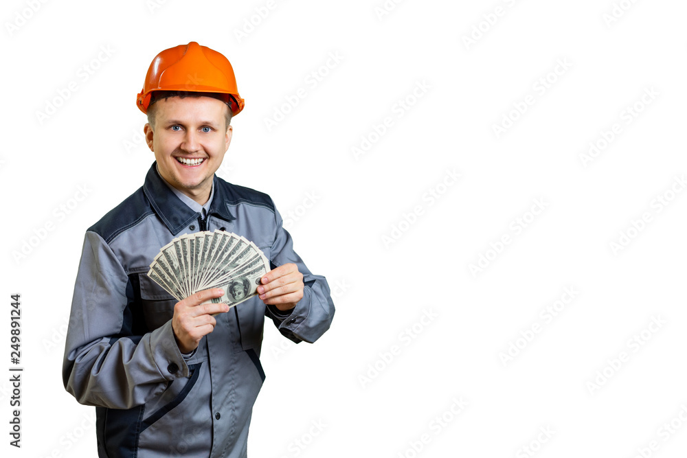Builder earn money, repairman holds cash, fan made out of banknotes in hand. Man in helmet got salary, money for work. Handyman in isolated background. Builder earn money, repairman holds cash, fan made out of banknotes in hand. Man in helmet got salary, money for work. Handyman in isolated background.