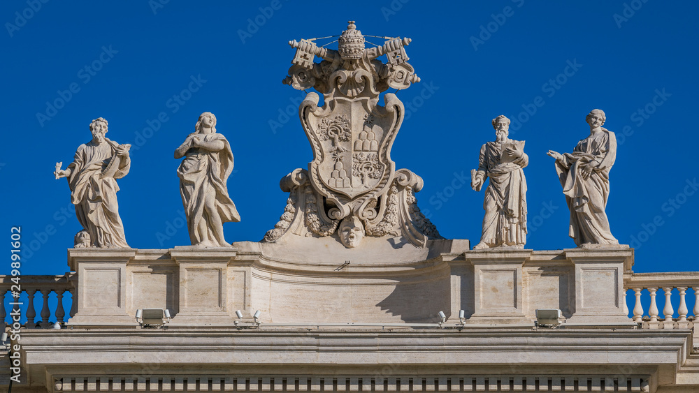 Alexander VII coat of arms and saints statues (Mark, Mary, Ephraim and Theodosia) in the colonnade of Saint Peter Basilica in Rome, Italy.